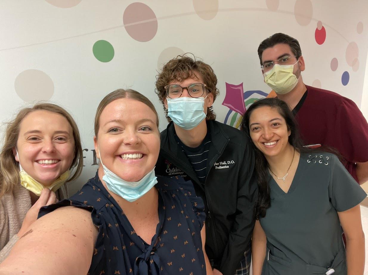 group picture of five residents, four of which are wearing surgical masks